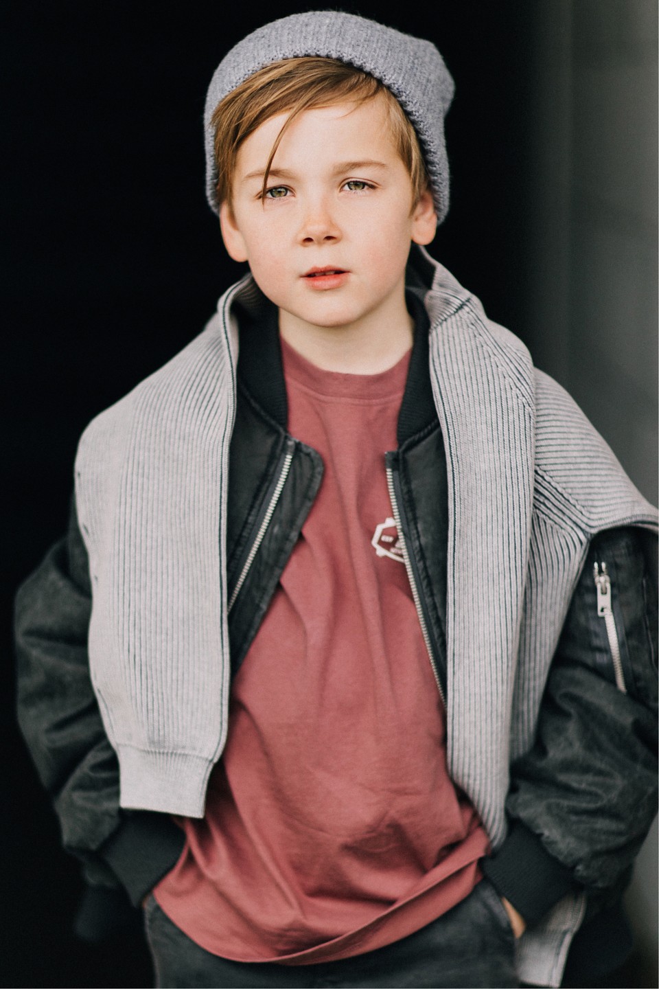 Young boy in a grey beanie and layered jacket